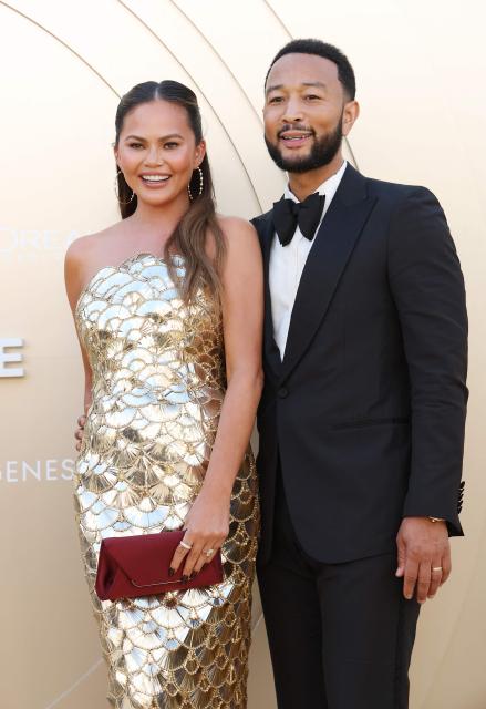 US model Chrissy Teigen (L) and US musician John Legend attend Gold House 4th Gold Gala at the Music Center in Los Angeles, May 10, 2025. Gold Gala, the annual gathering of top Asian Pacific and multicultural leaders, celebrates the 100 most impactful Asian Pacific changemakers in culture and society over the past year. (Photo by Michael Tran / AFP)
