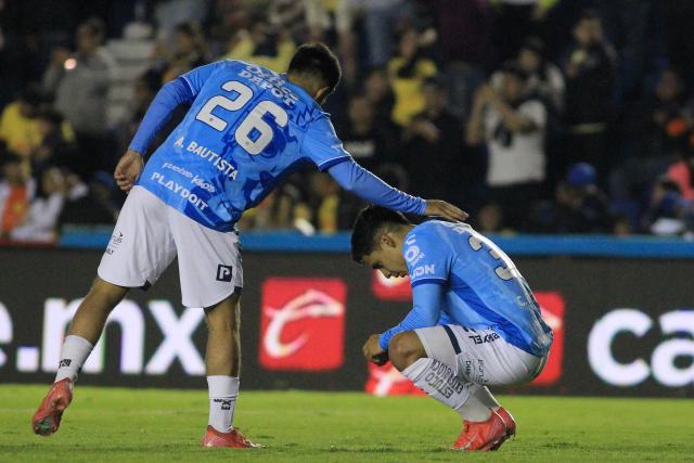 Pachuca's midfielder #26 Alan Bautista and defender #32 Carlos Sanchez react after losing the Liga MX Clausura tournament quarter-final second leg football match between America and Pachuca at the Sports City Stadium in Mexico City on May 10, 2025. (Photo by Victor Cruz / AFP)