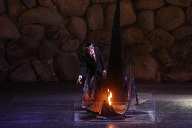 German Foreign Minister Johann Wadephul rekindles the Eternal Flame at the Hall of Remembrance at the Yad Vashem Holocaust Memorial museum in Jerusalem on May 11, 2025, during his visit to Israel. (Photo by GIL COHEN-MAGEN / AFP)