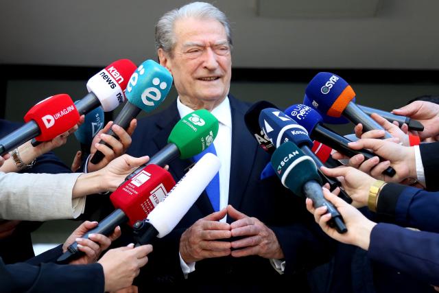 Chairman of the Democratic Party of Albania Sali Berisha speaks to press as he leaves a voting station in Tirana on May 11, 2025, during Albania's parliamentary election. Albanians head to the polls on May 11 to decide whether to give Prime Minister Edi Rama a fourth term or side with his longstanding rival in an election seen as crucial for the country's European Union ambitions. (Photo by STRINGER / AFP)