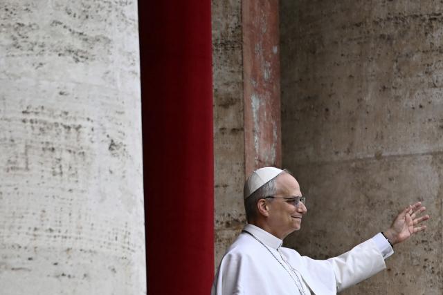 Pope Leo XIV waves after delivering the Regina Caeli prayer from the main central loggia of St Peter's basilica in The Vatican, on May 11, 2025. (Photo by Filippo MONTEFORTE / AFP)