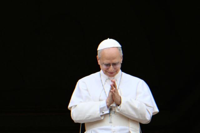 Pope Leo XIV greets the crowd during the Regina Caeli prayer from the main central loggia of St Peter's basilica in The Vatican, on May 11, 2025. (Photo by Alberto PIZZOLI / AFP)