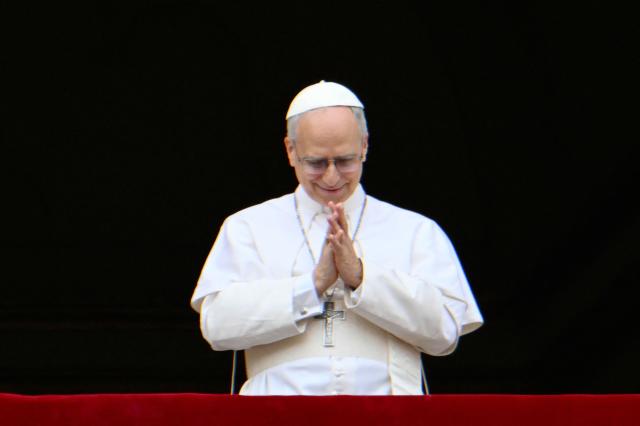 Pope Leo XIV greets the crowd after the Regina Caeli prayer from the main central loggia of St Peter's basilica in The Vatican, on May 11, 2025. (Photo by Alberto PIZZOLI / AFP)