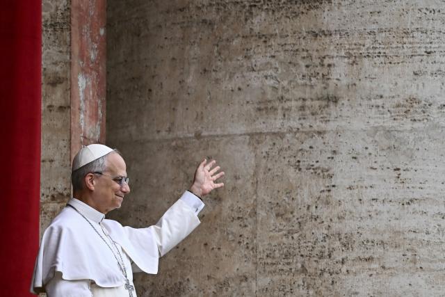 Pope Leo XIV waves after delivering the Regina Caeli prayer from the main central loggia of St Peter's basilica in The Vatican, on May 11, 2025. (Photo by Filippo MONTEFORTE / AFP)