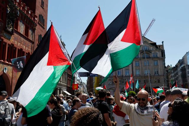 Protestors hold Palestinian flags as they attend a demonstration against Israel's candidate during the Eurovision Song Contest 2025 opening ceremony in Basel on May 11, 2025. (Photo by Stefan Wermuth / AFP)