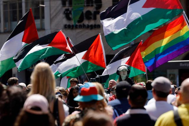 Protestors hold Palestinian and LGBTQI flags as they attend a demonstration against Israel's candidate during the Eurovision Song Contest 2025 opening ceremony in Basel on May 11, 2025. (Photo by Stefan Wermuth / AFP)