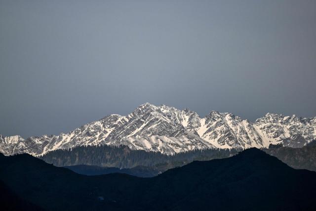 A general view of the snowcapped Himalayan mountain range as pictured from the border town of Poonch in India's Jammu region on May 11, 2025. A ceasefire appeared to hold on May 11 between India and Pakistan, hours after the nuclear-armed rivals accused each other of violating a truce that brought them back from the brink of all-out war. (Photo by Punit PARANJPE / AFP)