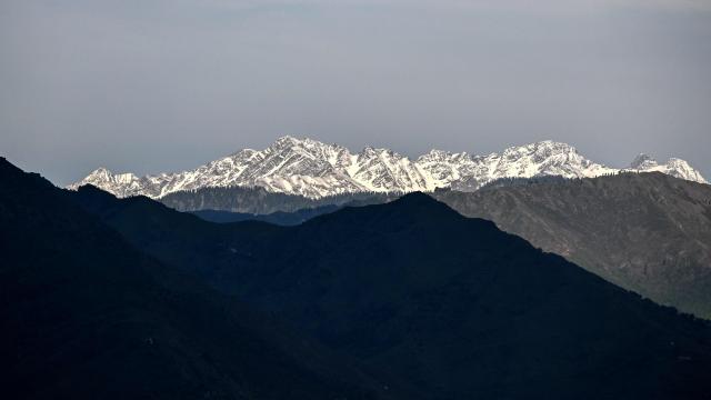 A general view of the snowcapped Himalayan mountain range as pictured from the border town of Poonch in India's Jammu region on May 11, 2025. A ceasefire appeared to hold on May 11 between India and Pakistan, hours after the nuclear-armed rivals accused each other of violating a truce that brought them back from the brink of all-out war. (Photo by Punit PARANJPE / AFP)