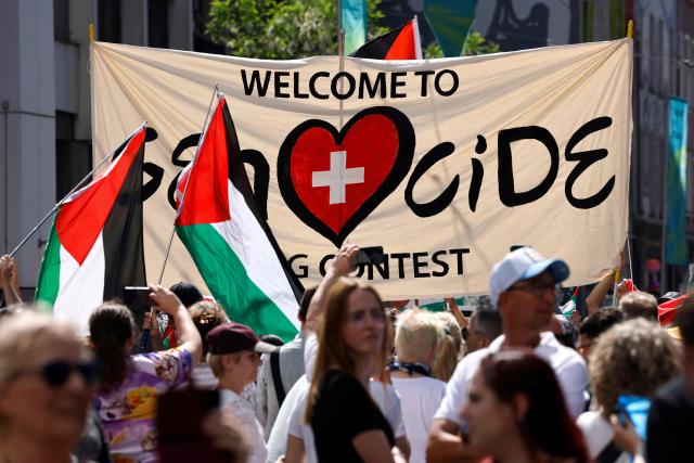 Protestors hold Palestinian flags and a banner as they take part in a demonstration against Israel's candidate and during the Eurovision Song Contest 2025 opening ceremony in Basel on May 11, 2025. (Photo by Stefan Wermuth / AFP)