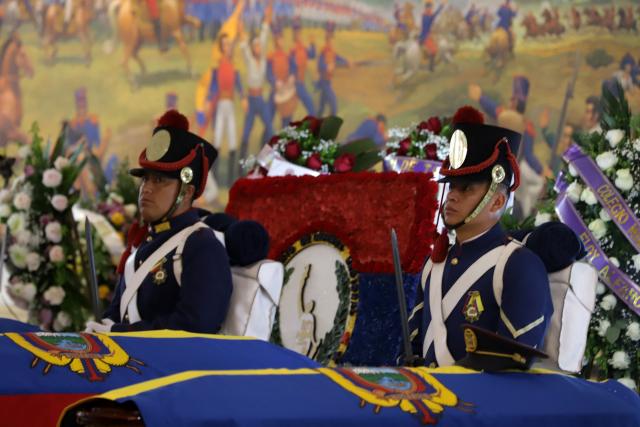Soldiers stand guard next tothe coffins of the 11 soldiers killed on May 9, during their wake at the Eloy Alfaro Military College in Quito on May 11, 2025. Ecuador declared three days of national mourning over the deaths of 11 soldiers who the army said were killed by dissident FARC guerrillas in an ambush in Alto Punino, near the Colombian border amid a spike in violence linked to the trafficking of cocaine. (Photo by ARMANDO PRADO / AFP)