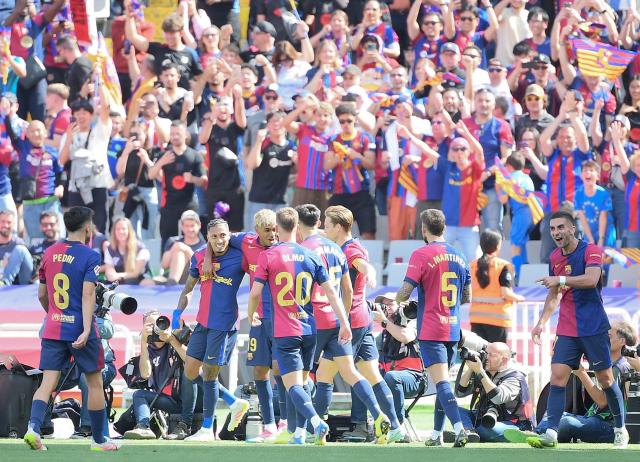 Barcelona players celebrate after scoring their third goal during the Spanish league football match between FC Barcelona and Real Madrid CF at Estadi Olimpic Lluis Companys in Barcelona, on May 11, 2025. (Photo by Josep LAGO / AFP)
