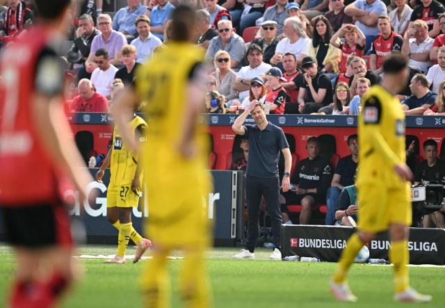 Bayer Leverkusen's Spanish head coach Xabi Alonso (C) reacts during the German first division Bundesliga football match between Bayer 04 Leverkusen and Borussia Dortmund in Leverkusen, western Germany, on May 11, 2025. (Photo by INA FASSBENDER / AFP) / DFL REGULATIONS PROHIBIT ANY USE OF PHOTOGRAPHS AS IMAGE SEQUENCES AND/OR QUASI-VIDEO