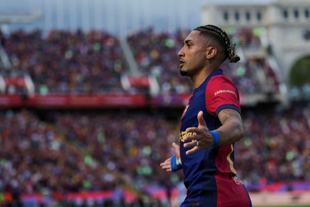 Barcelona's Brazilian forward #11 Raphinha celebrates scoring their third goal during the Spanish league football match between FC Barcelona and Real Madrid CF at Estadi Olimpic Lluis Companys in Barcelona, on May 11, 2025. (Photo by LLUIS GENE / AFP)