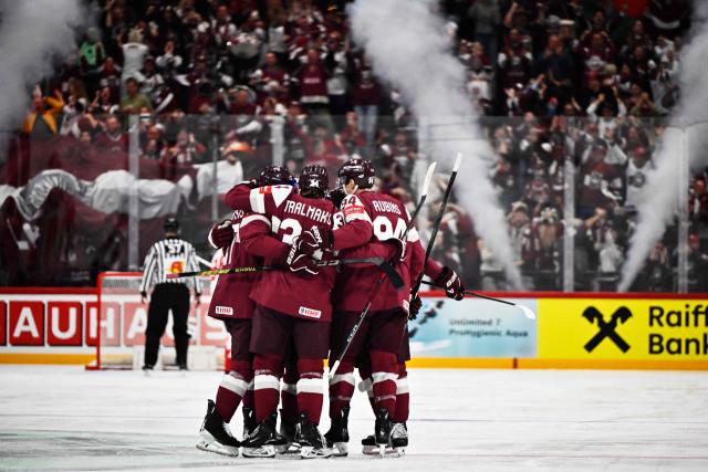 Latvia players celebrate scoring during the IIHF Ice Hockey World Championship group A match between Latvia and Canada at the Avicii Arena in Stockholm, Sweden, on May 11, 2025. (Photo by Christine OLSSON / various sources / AFP) / Sweden OUT