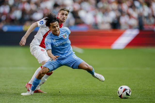Ajax' Dutch midfielder #08 Kenneth Taylor (L) fights for the ball with NEC Nimegue's  Japanese midfielder #23 Kodai Sano during the Dutch Eredivisie football match between Ajax Amsterdam and NEC Nimegue at the Johan Cruijff Arena in Amsterdam, on May 11, 2025. (Photo by Koen van Weel / ANP / AFP) / Netherlands OUT