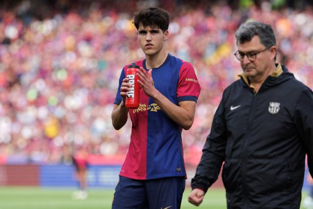Barcelona's Spanish defender #02 Pau Cubarsi injured leaves the pitch during the Spanish league football match between FC Barcelona and Real Madrid CF at Estadi Olimpic Lluis Companys in Barcelona, on May 11, 2025. (Photo by LLUIS GENE / AFP)