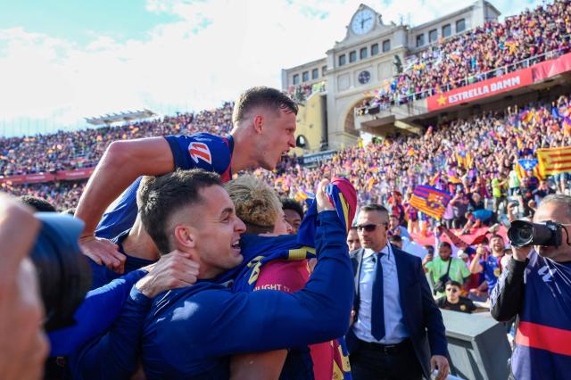 Barcelona's players celebrate victory at the end of the Spanish league football match between FC Barcelona and Real Madrid CF at Estadi Olimpic Lluis Companys in Barcelona, on May 11, 2025. Barcelona won 4-3. (Photo by Josep LAGO / AFP)
