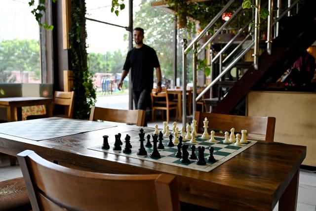 A chessboard is seen at the Cupcake Coffee Shop cafe in Kabul On May 11, 2025. Taliban authorities have barred chess across Afghanistan until further notice over concerns it is a source of gambling, which is illegal under the government's morality law, a sports official said on May 11. (Photo by Wakil KOHSAR / AFP)