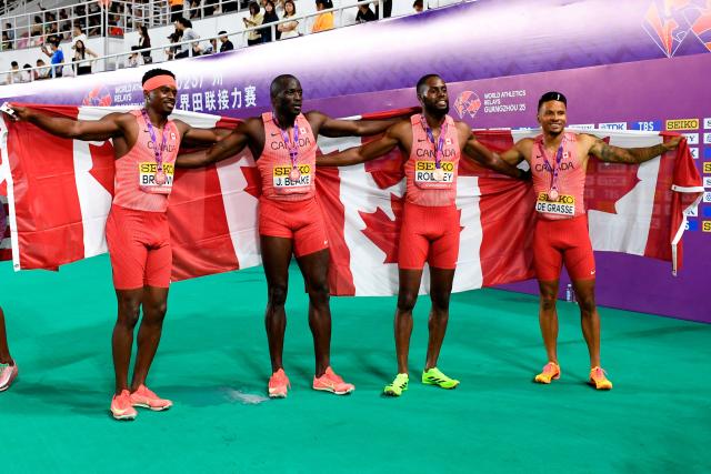 (L-R) Canada’s Aaron Brown, Jerome Blake, Brendon Rodney and Andre De Grasse pose for a picture after winning third place in the men’s 4x100m relay final of the World Athletics Relays Guangzhou 25 in Guangzhou, China’s Guangdong province on May 11, 2025. (Photo by WANG Zhao / AFP)