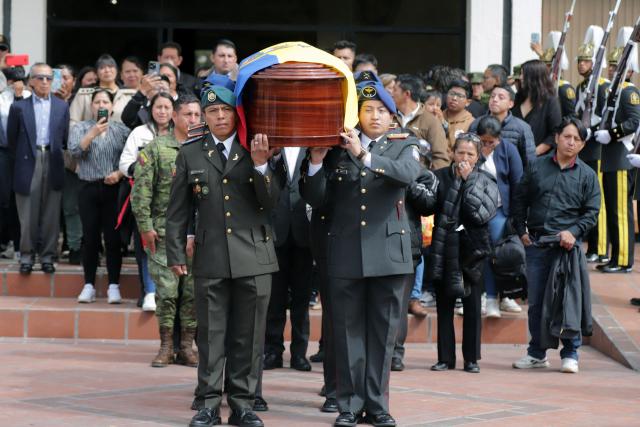 Relatives and friends of the 11 soldiers killed on May 9 accompany the coffins as they leave after the funeral mass at the Eloy Alfaro Military College in Quito on May 11, 2025. Ecuador declared three days of national mourning over the deaths of 11 soldiers who the army said were killed by dissident FARC guerrillas in an ambush in Alto Punino, near the Colombian border amid a spike in violence linked to the trafficking of cocaine. (Photo by ARMANDO PRADO / AFP)