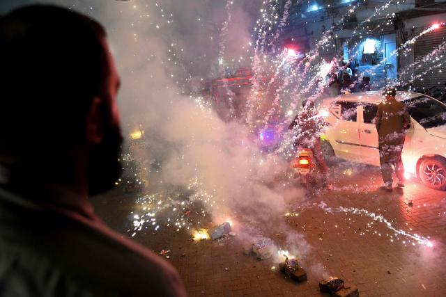 TOPSHOT - Pakistan Peoples Party (PPP) activists light up fireworks during a march expressing solidarity with the country's armed forces as they celebrate after a ceasefire between Pakistan and India, in Larkana, Sindh province on May 11, 2025. A ceasefire appeared to hold on May 11, 2025, between India and Pakistan, hours after the nuclear-armed rivals accused each other of violating a truce that brought them back from the brink of all-out war. The ceasefire was agreed on May 10, 2025, after four days of missile, drone and artillery attacks which killed at least 60 people and sent thousands fleeing, in the worst violence since India and Pakistan's last open conflict in 1999. (Photo by Ahmed Raza SOOMRO / AFP)