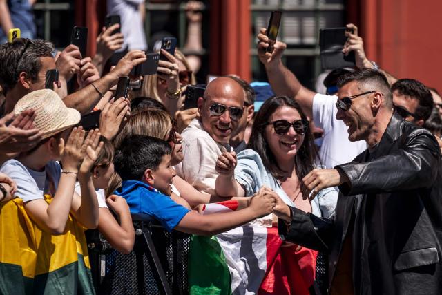 Italian singer Gabry Ponte representing San Marino with the song 'Tutta L’Italia' reacts with fans during the turquoise carpet event next to the Basel Town Hall during the opening ceremony of the Eurovision Song Contest 2025 in Basel on May 11, 2025. (Photo by Fabrice COFFRINI / AFP)