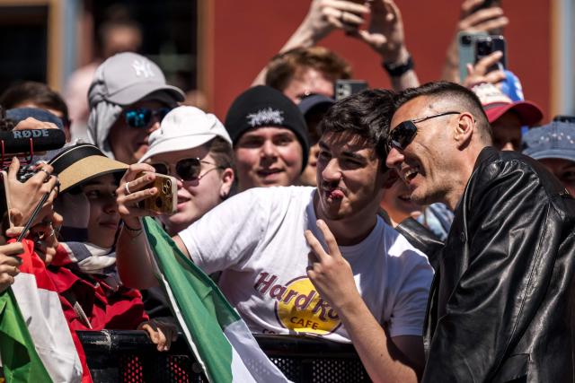 Italian singer Gabry Ponte representing San Marino with the song 'Tutta L’Italia' poses with fans during the turquoise carpet event next to the Basel Town Hall during the opening ceremony of the Eurovision Song Contest 2025 in Basel on May 11, 2025. (Photo by Fabrice COFFRINI / AFP)