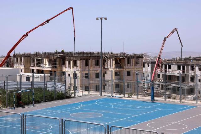 Vehicles pump concrete at a construction site for a housing project in the Israeli settlement of Har Brakha, south of Nablus in the occupied West Bank on May 11, 2025. (Photo by Menahem Kahana / AFP)