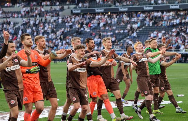 St. Pauli players celebrate after the German first division Bundesliga football match between Eintracht Frankfurt and FC St. Pauli in Frankfurt, western Germany, on May 11, 2025. (Photo by Daniel ROLAND / AFP) / DFL REGULATIONS PROHIBIT ANY USE OF PHOTOGRAPHS AS IMAGE SEQUENCES AND/OR QUASI-VIDEO