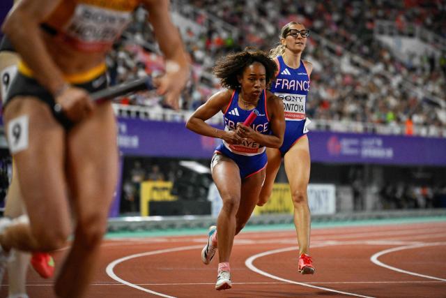 France's Diana Iscaye (C) takes the relay as she competes in the women's 4x400m relay final of the World Athletics Relays Guangzhou25 in Guangzhou, China’s Guangdong province on May 11, 2025. (Photo by WANG Zhao / AFP)