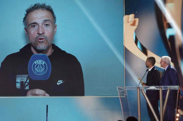 Paris Saint-Germain's Spanish head coach Luis Enrique (on secreen) delivers a speech after receiving the French Ligue 1 football's Best Coach award during televised the UNFP (French National Professional Football players Union) trophy ceremony, in Paris on May 11, 2025. (Photo by FRANCK FIFE / AFP)