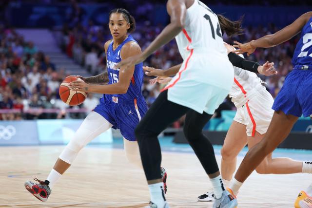 (FILES) France's #15 Gabby Williams dribbles the ball past in the women's preliminary round group B basketball match between Canada and France during the Paris 2024 Olympic Games at the Pierre-Mauroy stadium in Villeneuve-d'Ascq, northern France, on July 29, 2024. The star winger of the French women's basketball team, Gabby Williams, announced on May 11, 2025, that she would not be taking part in the Euro-2025 basketball tournament starting this upcoming June 18th, that France's "Les Bleues" will be playing in Greece. "It's a personal choice that I haven't taken lightly, and I'll remain the first supporter of the French team", the 28-year-old wrote on Instagram, without saying whether her decision was linked to the constraints of her contract in the WNBA, the North American basketball league. (Photo by Thomas COEX / AFP)