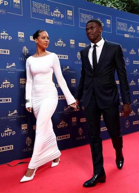 Paris Saint-Germain's Portuguese defender #25 Nuno Mendes (R) and his partner Thalyta Silva arrive to attend the televised UNFP (French National Professional Football players Union) trophy ceremony, in Paris on May 11, 2025. (Photo by FRANCK FIFE / AFP)