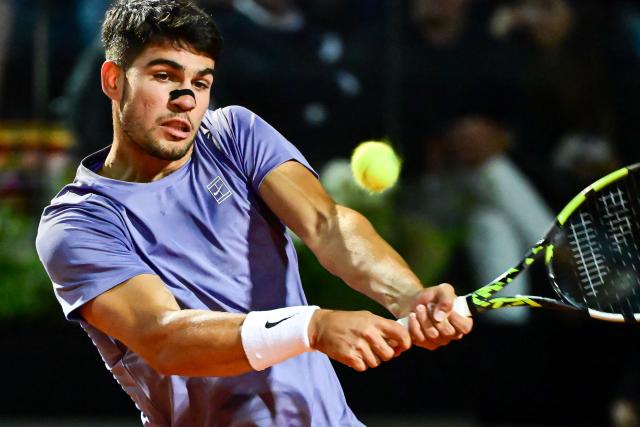 Spain's Carlos Alcaraz returns a shot to Serbia's Laslo Djere during their men's singles match for the ATP Rome Open tennis tournament at Foro Italico in Rome on May 11, 2025. (Photo by PIERO CRUCIATTI / AFP)