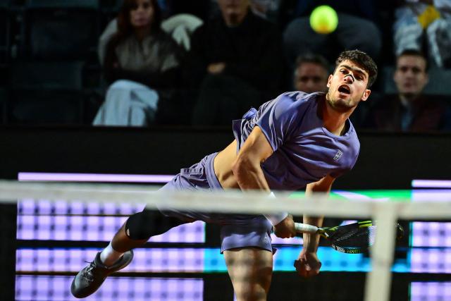 Spain's Carlos Alcaraz returns a shot to Serbia's Laslo Djere during their men's singles match for the ATP Rome Open tennis tournament at Foro Italico in Rome on May 11, 2025. (Photo by PIERO CRUCIATTI / AFP)