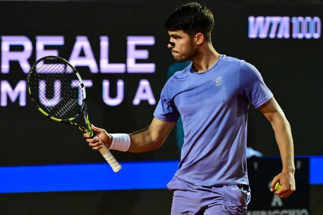 Spain's Carlos Alcaraz celebrates after winning his men's singles match against Serbia's Laslo Djere during the ATP Rome Open tennis tournament at Foro Italico in Rome on May 11, 2025. (Photo by PIERO CRUCIATTI / AFP)