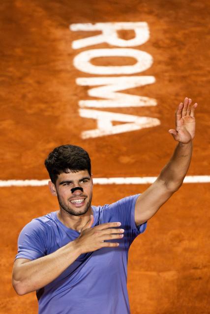 Spain's Carlos Alcaraz celebrates after winning his men's singles match against Serbia's Laslo Djere during the ATP Rome Open tennis tournament at Foro Italico in Rome on May 11, 2025. (Photo by MARCO BERTORELLO / AFP)