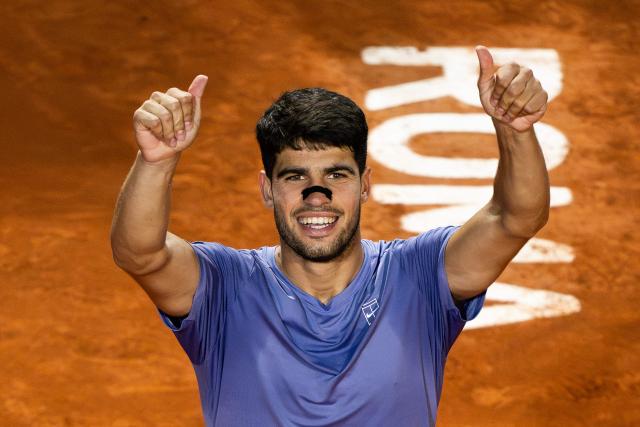 Spain's Carlos Alcaraz celebrates after winning his men's singles match against Serbia's Laslo Djere during the ATP Rome Open tennis tournament at Foro Italico in Rome on May 11, 2025. (Photo by MARCO BERTORELLO / AFP)