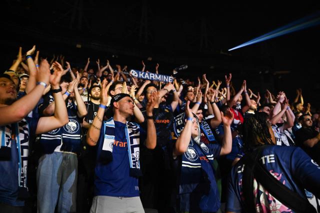 Karmine Corp's supporters cheer as they attend the League of Legends EMEA Championship (LEC) Roadtrip - eSports competition at Les Arenes in Evry-Courcouronnes, suburb of Paris,  on May 11, 2025. (Photo by Leo VIGNAL / AFP)