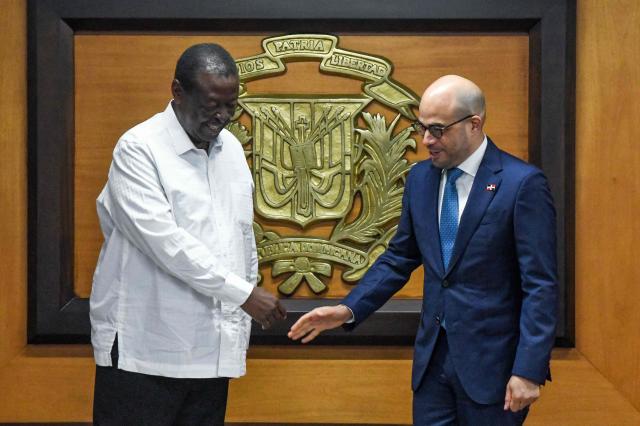 Kenyan Prime Cabinet Secretary and Cabinet Secretary for Foreign Affairs Musalia Mudavadi (L) shakes hands with Dominican Republic's Vice Minister of Bilateral Foreign Policy Francisco Caraballo during a meeting in Santo Domingo on May 11, 2025. (Photo by Eddy Vittini / AFP)