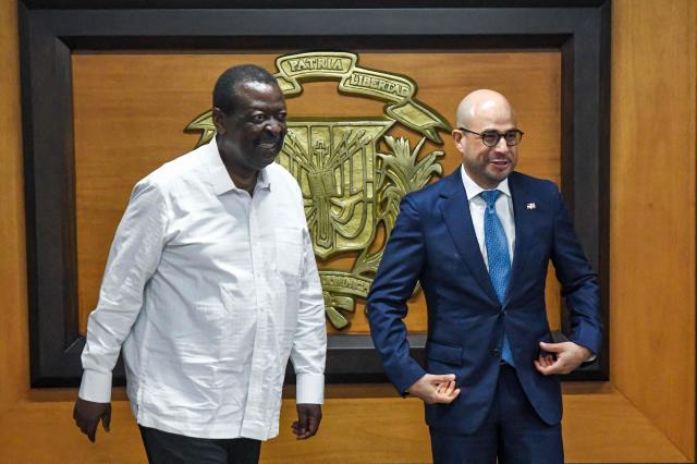 Kenyan Prime Cabinet Secretary and Cabinet Secretary for Foreign Affairs Musalia Mudavadi (L) and Dominican Republic's Vice Minister of Bilateral Foreign Policy Francisco Caraballo gesture after posing for a picture during a meeting in Santo Domingo on May 11, 2025. (Photo by Eddy Vittini / AFP)