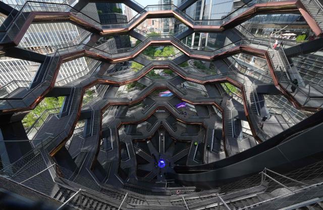 People walk around on the Vessel at Hudson Yards in New York city on May 11, 2025. The Vessel reopened in October 2024 after being closed for three years, now with netting aimed at decreasing the risk of suicides like the ones that forced its closure. (Photo by TIMOTHY A. CLARY / AFP)