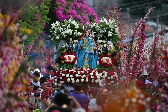 The image of the Virgin Mary is seen carried by Catholic faithful during the Panchimalco Flower and Palm Festival procession in Panchimalco, El Salvador on May 11, 2025. (Photo by Marvin RECINOS / AFP)