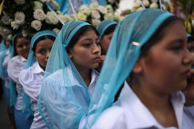 Catholic faithful carry the image of the Virgin Mary during the Panchimalco Flower and Palm Festival procession in Panchimalco, El Salvador on May 11, 2025. (Photo by Marvin RECINOS / AFP)