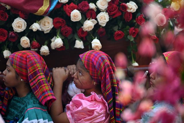 Catholic faithful carry the image of the Virgin Mary during the Panchimalco Flower and Palm Festival procession in Panchimalco, El Salvador on May 11, 2025. (Photo by Marvin RECINOS / AFP)