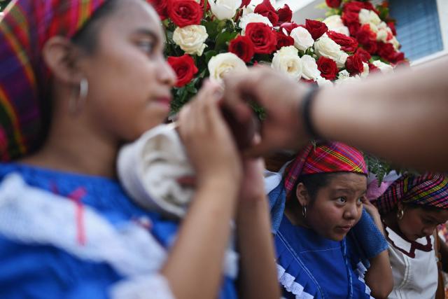 Catholic faithful carry the image of the Virgin Mary during the Panchimalco Flower and Palm Festival procession in Panchimalco, El Salvador on May 11, 2025. (Photo by Marvin RECINOS / AFP)