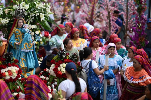 Catholic faithful carry the image of the Virgin Mary during the Panchimalco Flower and Palm Festival procession in Panchimalco, El Salvador on May 11, 2025. (Photo by Marvin RECINOS / AFP)