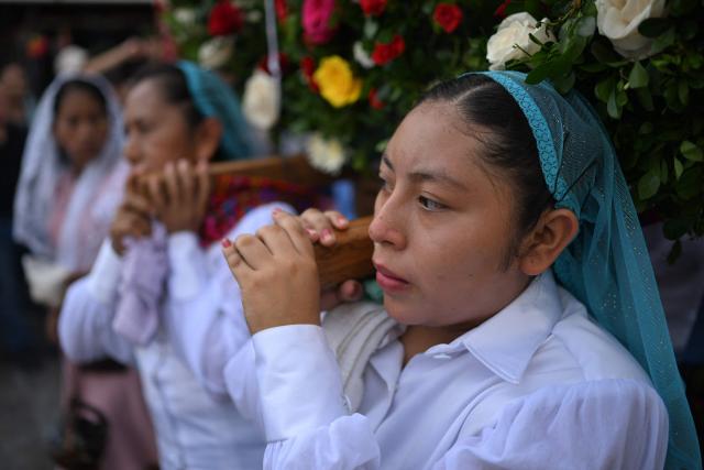 Catholic faithful carry the image of the Virgin Mary during the Panchimalco Flower and Palm Festival procession in Panchimalco, El Salvador on May 11, 2025. (Photo by Marvin RECINOS / AFP)
