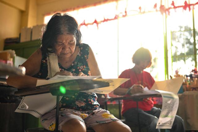 People vote at a polling station during mid-term elections in Manila on May 12, 2025. Millions of Filipinos headed to the polls May 12 in a mid-term election widely seen as a referendum on the explosive feud between President Ferdinand Marcos and impeached Vice President Sara Duterte. (Photo by Jam STA ROSA / AFP)