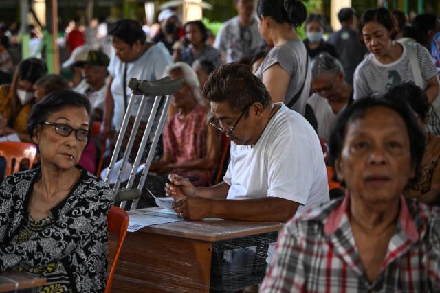 A man (C) votes at a polling station during mid-term elections in Manila on May 12, 2025. Millions of Filipinos headed to the polls May 12 in a mid-term election widely seen as a referendum on the explosive feud between President Ferdinand Marcos and impeached Vice President Sara Duterte. (Photo by Jam STA ROSA / AFP)